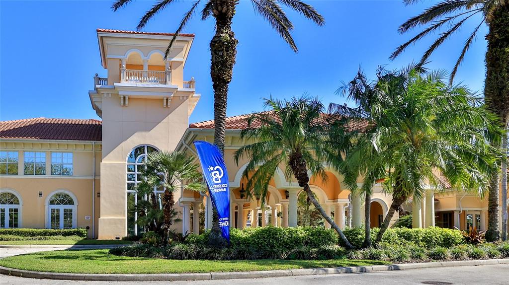 The exterior of a beige building features a tower, arched windows, and surrounding palm trees — 1 HAMMOCK BEACH PARKWAY, PALM COAST, FL