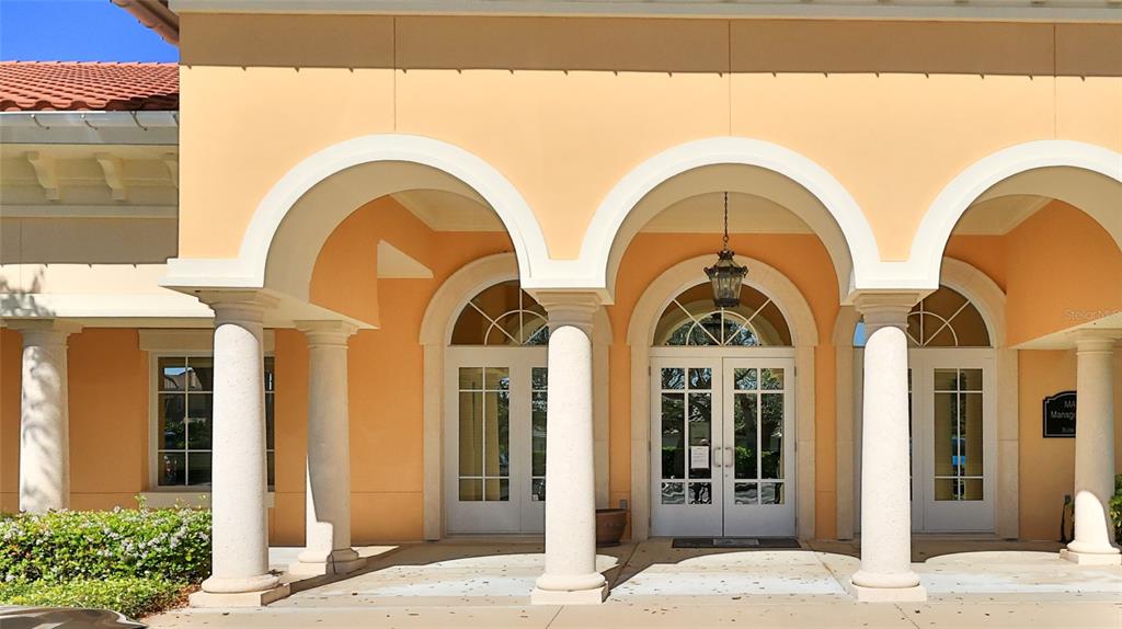 The exterior of a building features a covered entrance with arched doorways and white columns — 1 HAMMOCK BEACH PARKWAY, PALM COAST, FL