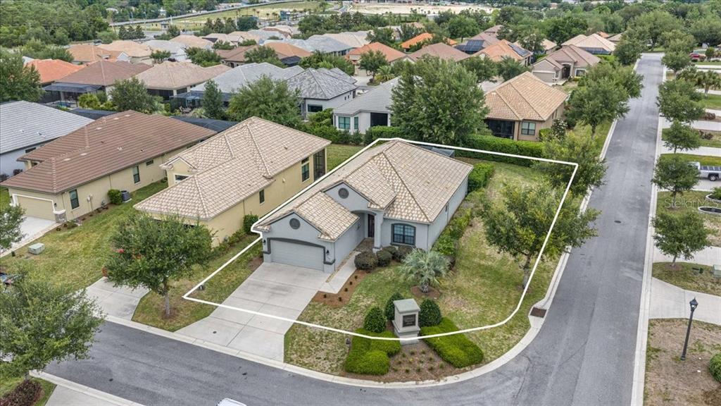 An aerial view shows a single-story house with a tiled roof and a corner lot — 1763 W TWILIGHT LANE, HERNANDO, FL