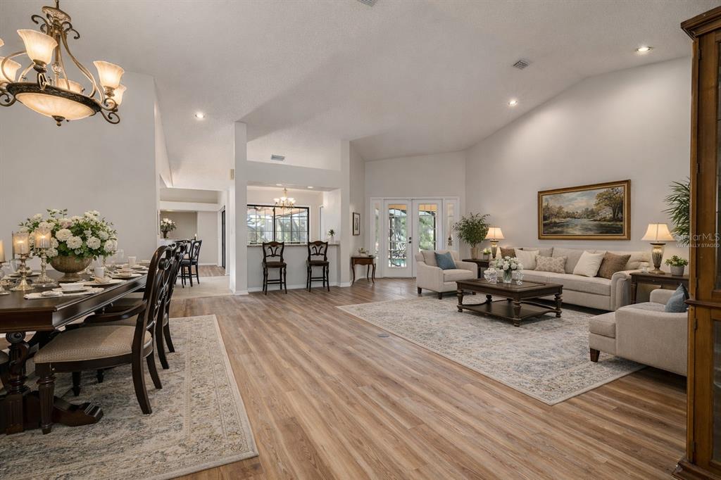 An entryway features double glass-paneled doors, a decorative metal console table, and beige tile flooring — 470 HICKORYNUT AVENUE, OLDSMAR, FL