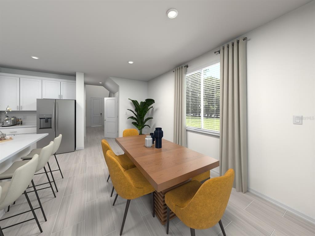 This is a digital rendering of a dining area and kitchen with light wood-look flooring — 1777 ARCHER DRIVE, MINNEOLA, FL
