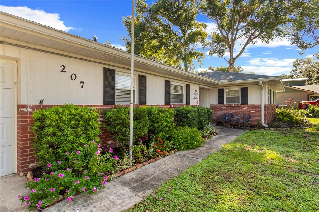A single-story house with a brick and stucco exterior, a walkway, and front landscaping — 207 W WHEELER ROAD, SEFFNER, FL