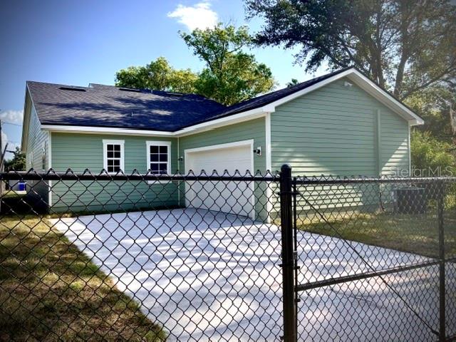 A light green, single-story house with a front porch and a gabled roof — 1137 DOROTHY STREET, LAKELAND, FL