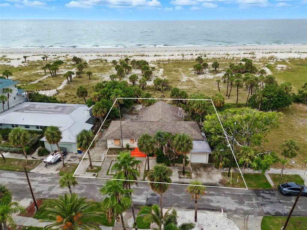 An aerial view shows a single-story house with a shingled roof located near the beach — 1024 ELDORADO AVENUE, CLEARWATER BEACH, FL