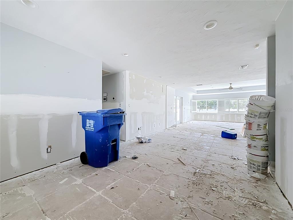 An unfinished room with bare drywall, a blue trash bin, and a stack of buckets — 2010 BAYOU GRANDE BOULEVARD NE, ST PETERSBURG, FL