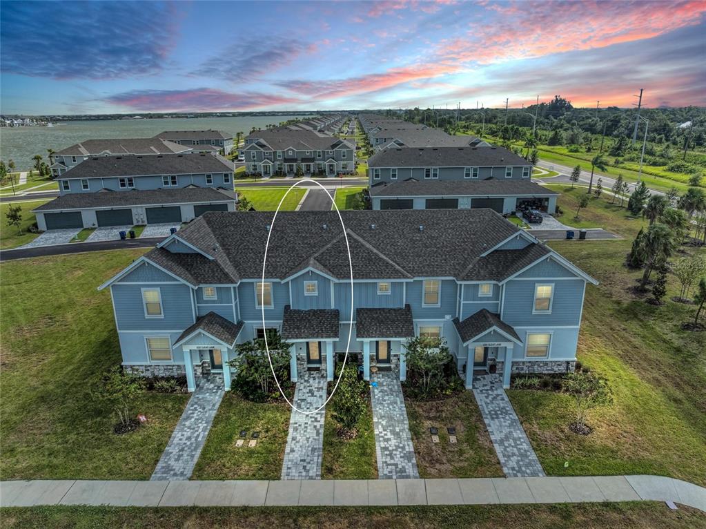An aerial view of a blue multi-unit townhouse with a circled entryway and roofline — 1741 CLEAT LANE, SARASOTA, FL