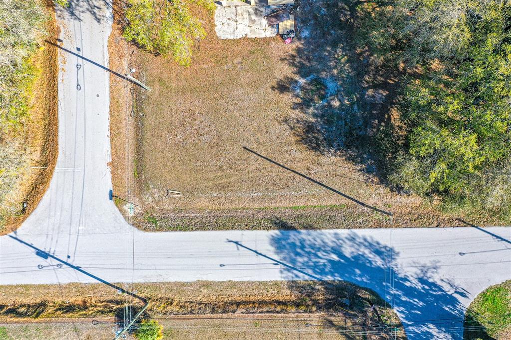 An aerial view shows a vacant, rectangular lot situated at a road intersection — CENTRAL AVENUE, MULBERRY, FL