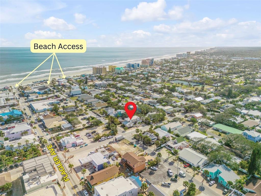 This is an aerial view of a coastal neighborhood with a marked property location — 201 S COOPER STREET, NEW SMYRNA BEACH, FL