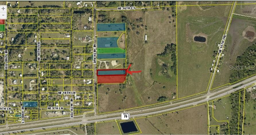 This aerial map shows a rectangular parcel of land highlighted in red along a road — 1132 NE 48TH AVENUE, OKEECHOBEE, FL