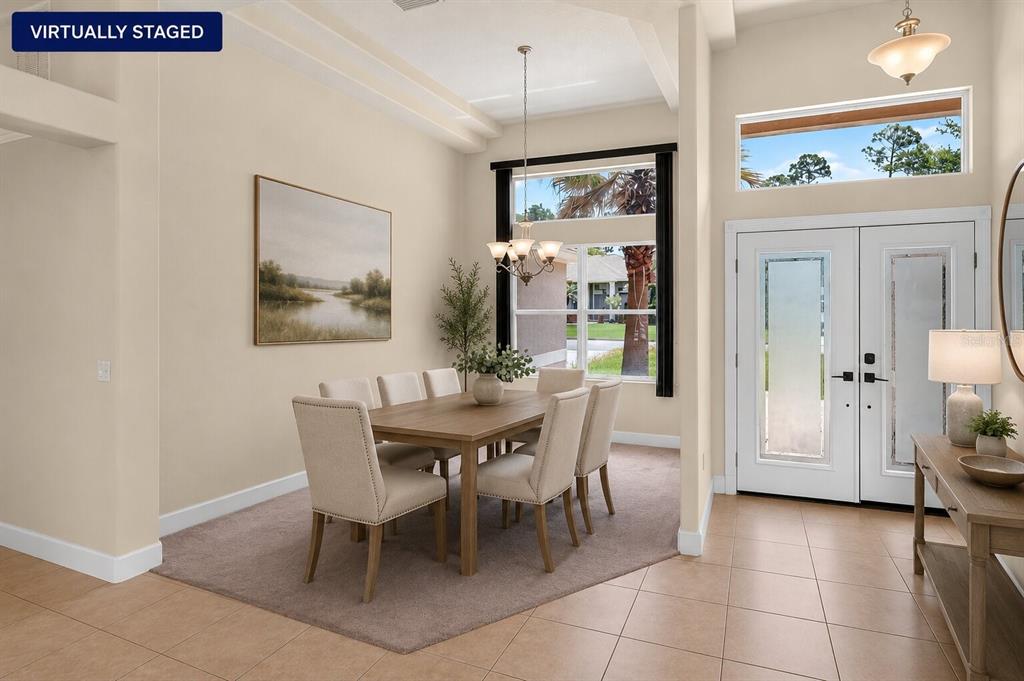 A dining area with a table and chairs sits next to a tiled entryway — 180 BLACK HICKORY WAY, ORMOND BEACH, FL