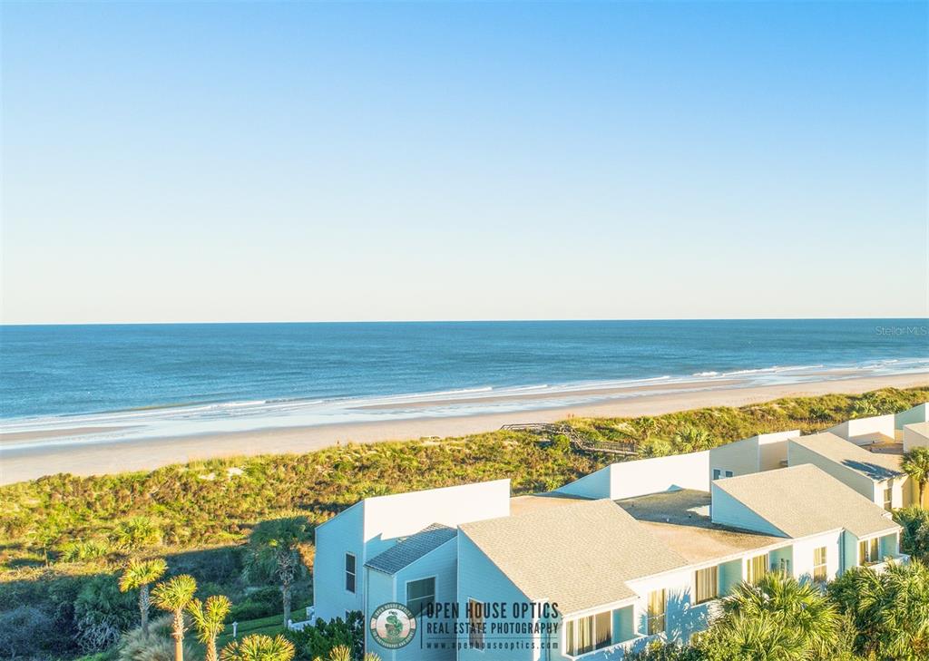 An aerial view shows a beach house complex situated next to a sandy ocean beach — 6300 A1A S UNIT A41U, ST AUGUSTINE, FL