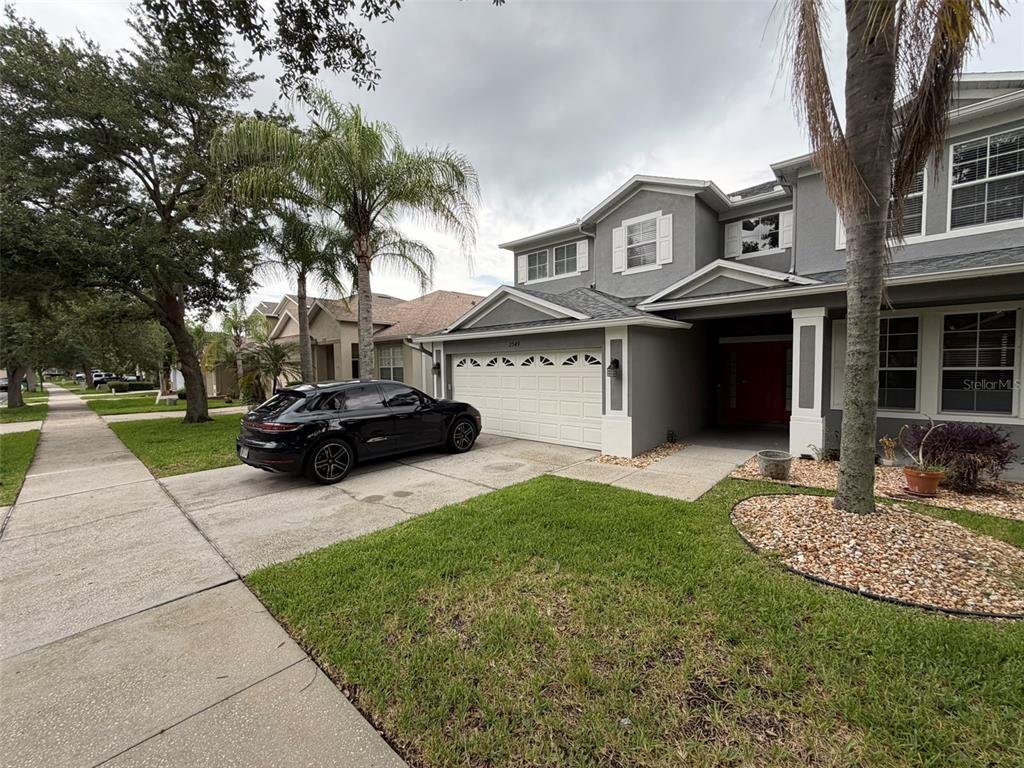 A two-story gray house with a white garage door and a black car parked outside — 2549 BALFORN TOWER WAY, WINTER GARDEN, FL
