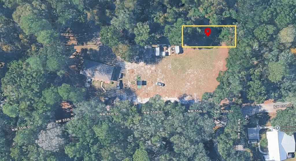 This aerial map view shows a house and a highlighted wooded lot — NW 55TH STREET, GAINESVILLE, FL