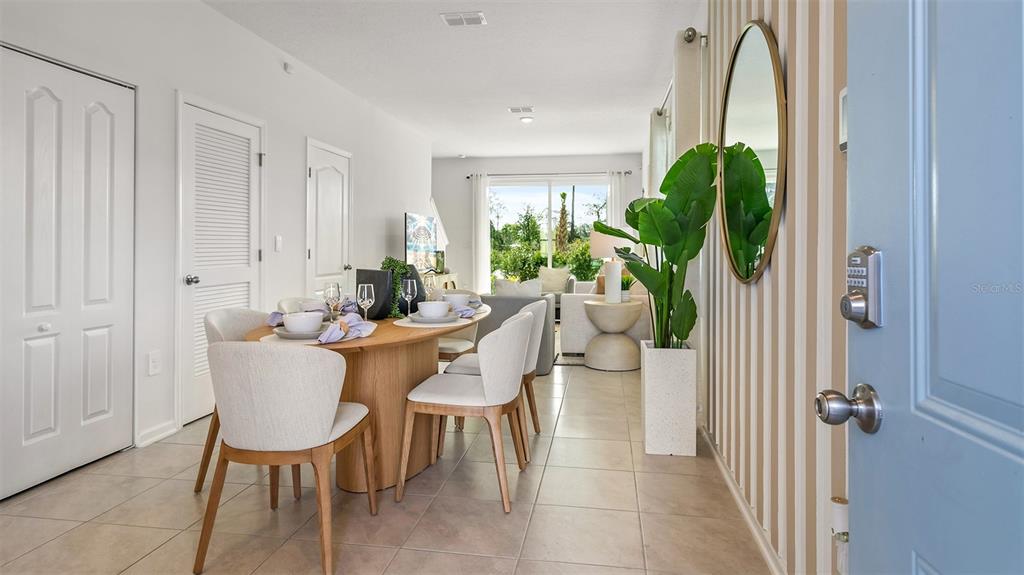 A dining area and living room are visible from an open doorway with striped wallpaper — 243 PALMETTO RIDGE ROAD, ST AUGUSTINE, FL