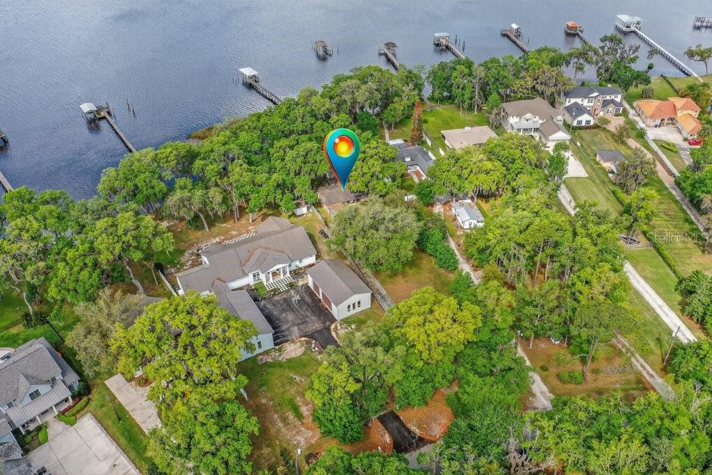 An aerial view shows a waterfront house with a detached garage and a private dock — 6373 JACK WRIGHT ISLAND ROAD, ST AUGUSTINE, FL