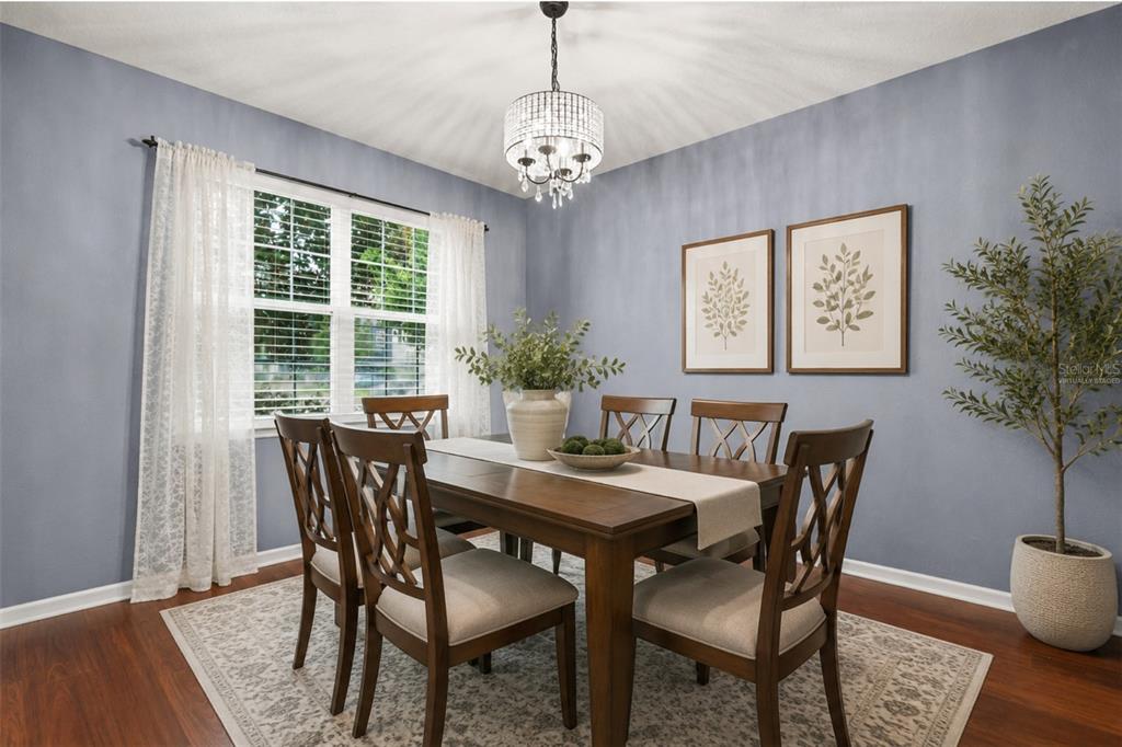 A dining room features a wooden table, six chairs, a chandelier, and blue-painted walls — 925 COUNTS CREST CIRCLE, APOPKA, FL