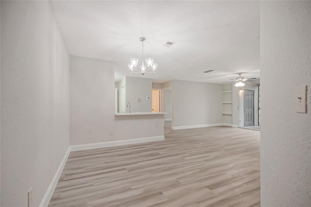A white front door sits at the end of a small tiled entryway — 7511 SEURAT STREET UNIT 10102, ORLANDO, FL