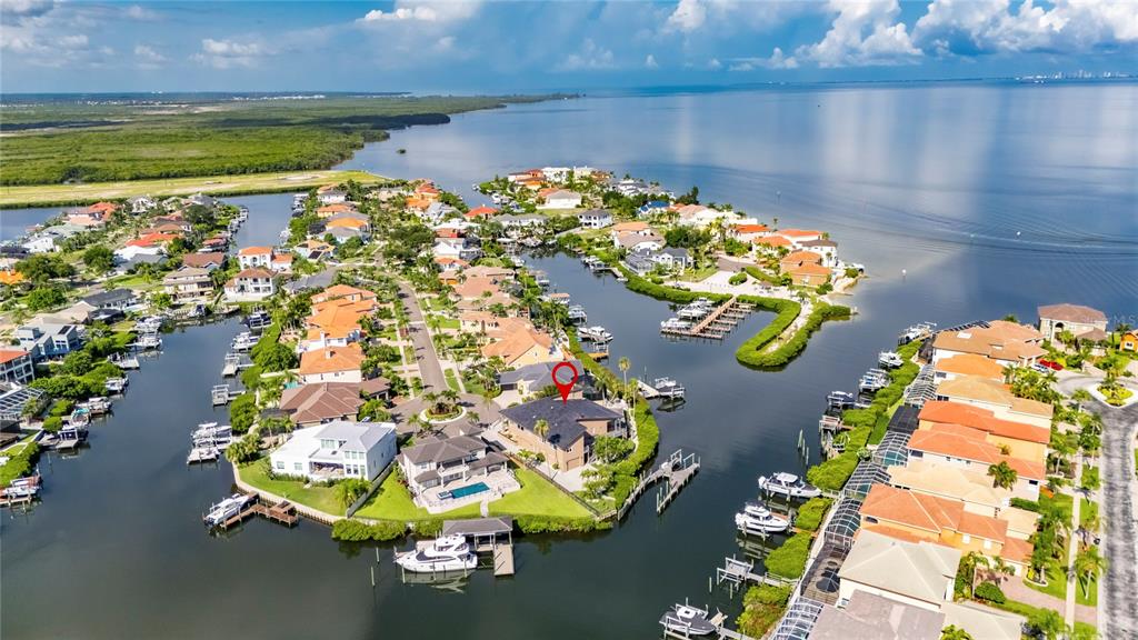 An aerial view shows waterfront houses with private docks along a canal in Florida — 903 CAPRICCIO LANE, APOLLO BEACH, FL