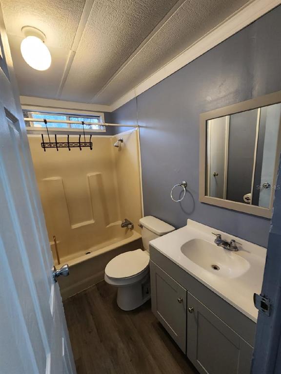 A bathroom features a gray vanity, a toilet, and a beige tub-shower combination — 5010, 5040, 5080, & 5120 S BARKER POINT, LECANTO, FL