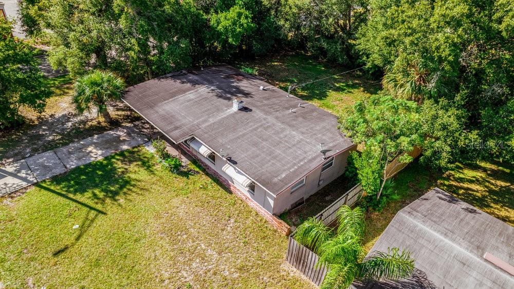An aerial view shows a single-story house with a flat roof and a large yard — 1406 CONWAY ROAD, ORLANDO, FL