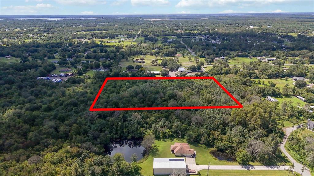 An aerial view shows a rectangular plot of land outlined in red near a house — 0 EDSEL AVENUE, ST CLOUD, FL