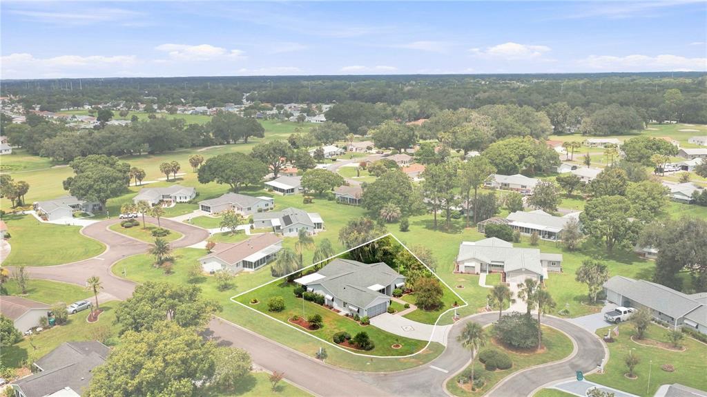 An aerial view shows a single-story house with a gray roof and a circular driveway — 17790 SE 101ST COURT, SUMMERFIELD, FL