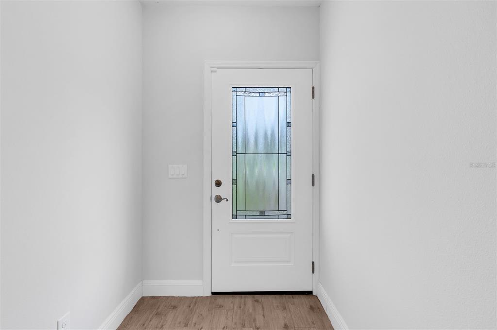 A long hallway features light wood-look tile flooring, white walls, and recessed ceiling lighting — 226 HAVERSHAM ROAD, DELTONA, FL