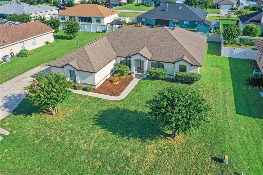An aerial view of a single-story suburban house with a brown roof and green lawn — 5659 SW 89TH PLACE, OCALA, FL