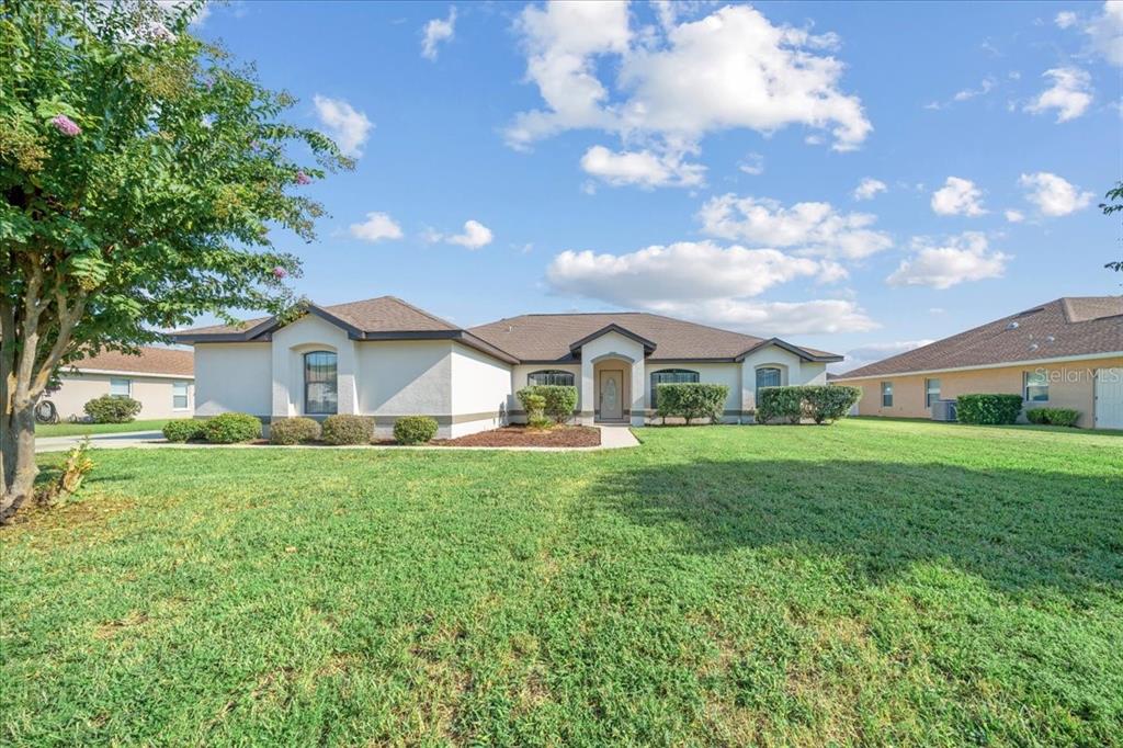 A single-story house with a beige stucco exterior and a brown shingled roof — 5659 SW 89TH PLACE, OCALA, FL