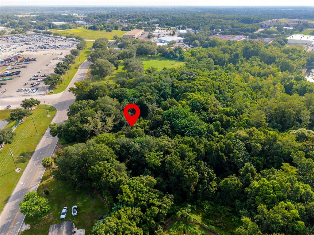 An aerial view shows a red location pin over a dense, wooded lot near a road — 923 MARSHALL FARMS ROAD, OCOEE, FL