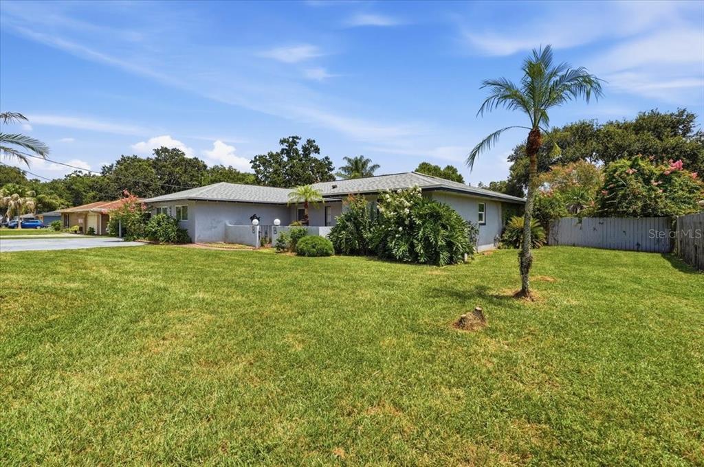 A single-story house with a gray exterior, a shingled roof, and a large front lawn — 543 STATE ROAD 559, AUBURNDALE, FL