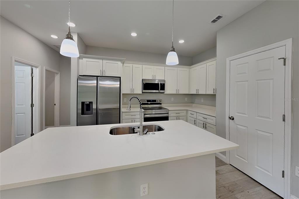 A kitchen with white cabinets, stainless steel appliances, and a central island with a sink — 3212 W MARIE DRIVE, CITRUS SPRINGS, FL