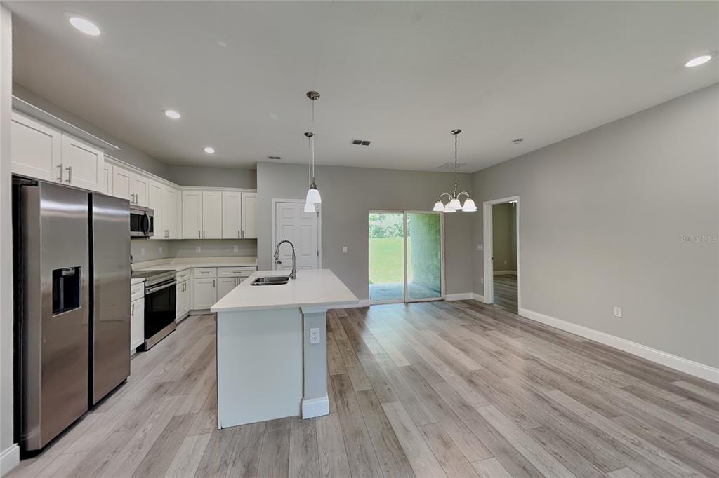 A kitchen with white cabinets, stainless steel appliances, and a central island with a sink — 3212 W MARIE DRIVE, CITRUS SPRINGS, FL