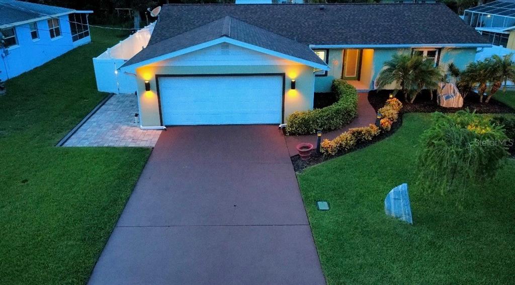 An aerial view of a single-story house with a two-car garage and landscaped front yard — 19 SANCHEZ AVENUE, ORMOND BEACH, FL