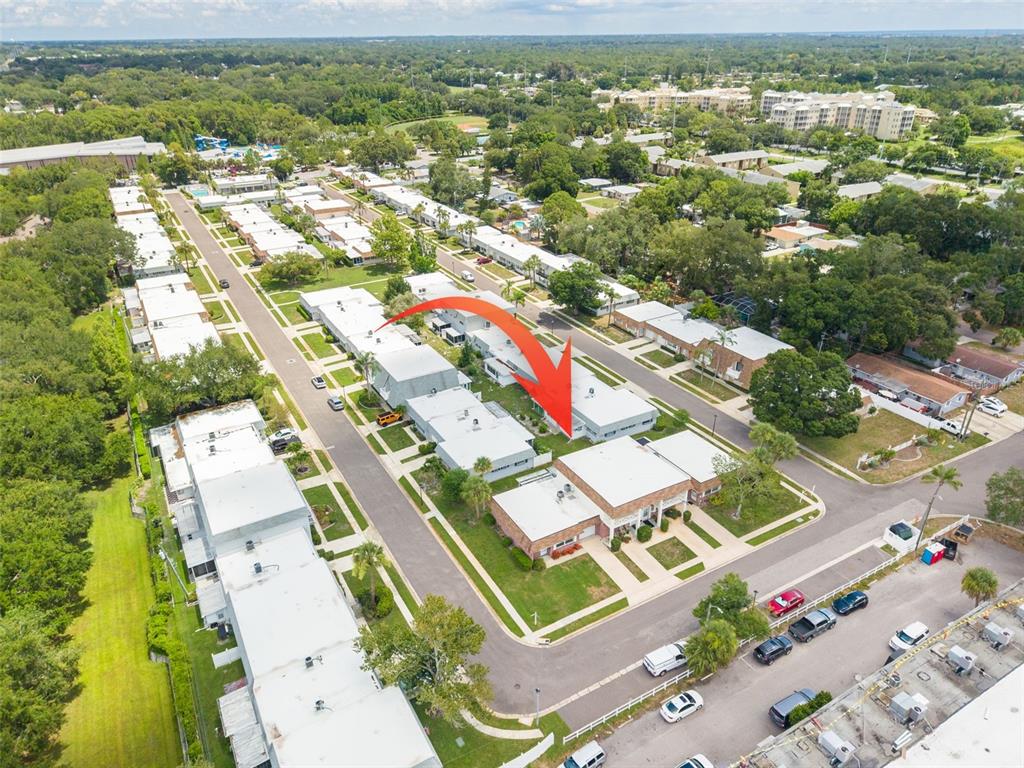 An aerial view shows a residential complex with multiple flat-roofed buildings and parking areas — 802 MINDY COURT UNIT 802, LARGO, FL