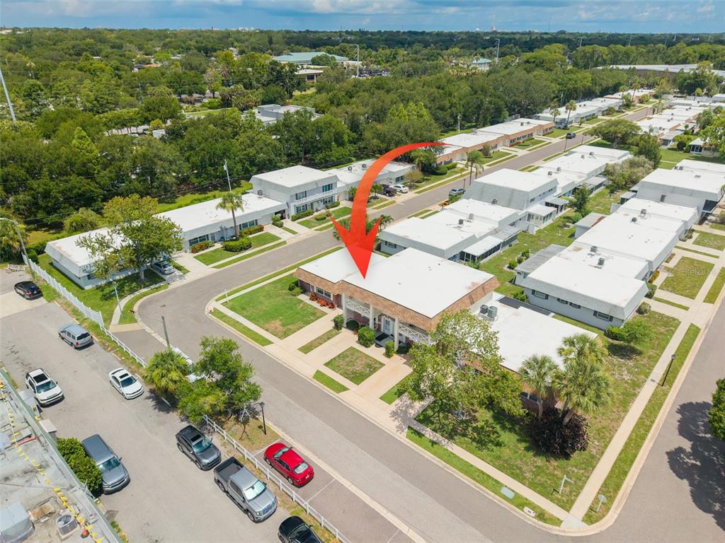 An aerial view shows a two-story residential building with a flat roof and surrounding landscaping — 802 MINDY COURT UNIT 802, LARGO, FL
