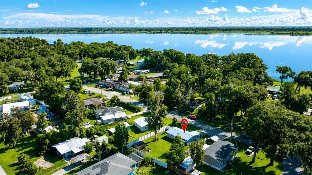 Aerial view of a residential neighborhood with a marked house near a large lake — 1924 CR 439C, LAKE PANASOFFKEE, FL
