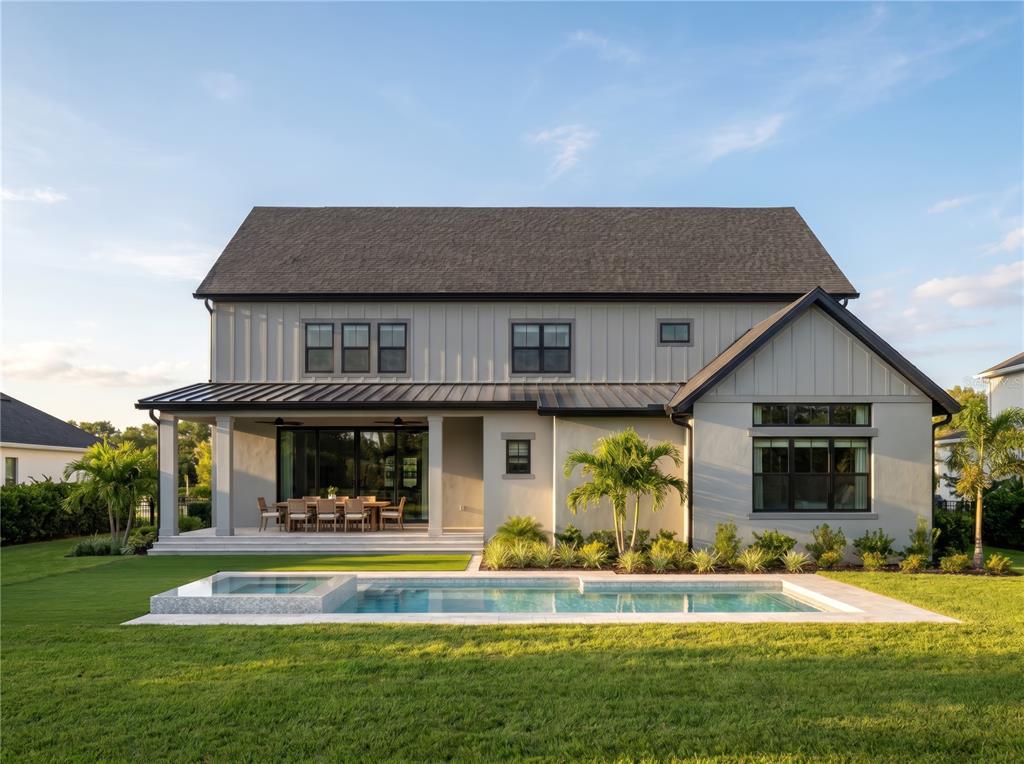 A two-story house with vertical siding, a covered patio, and a rectangular swimming pool — 1152 PRADO LANE, OAKLAND, FL