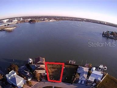 An aerial view shows a vacant waterfront lot outlined in red along a bay — 376 145TH AVENUE E, MADEIRA BEACH, FL