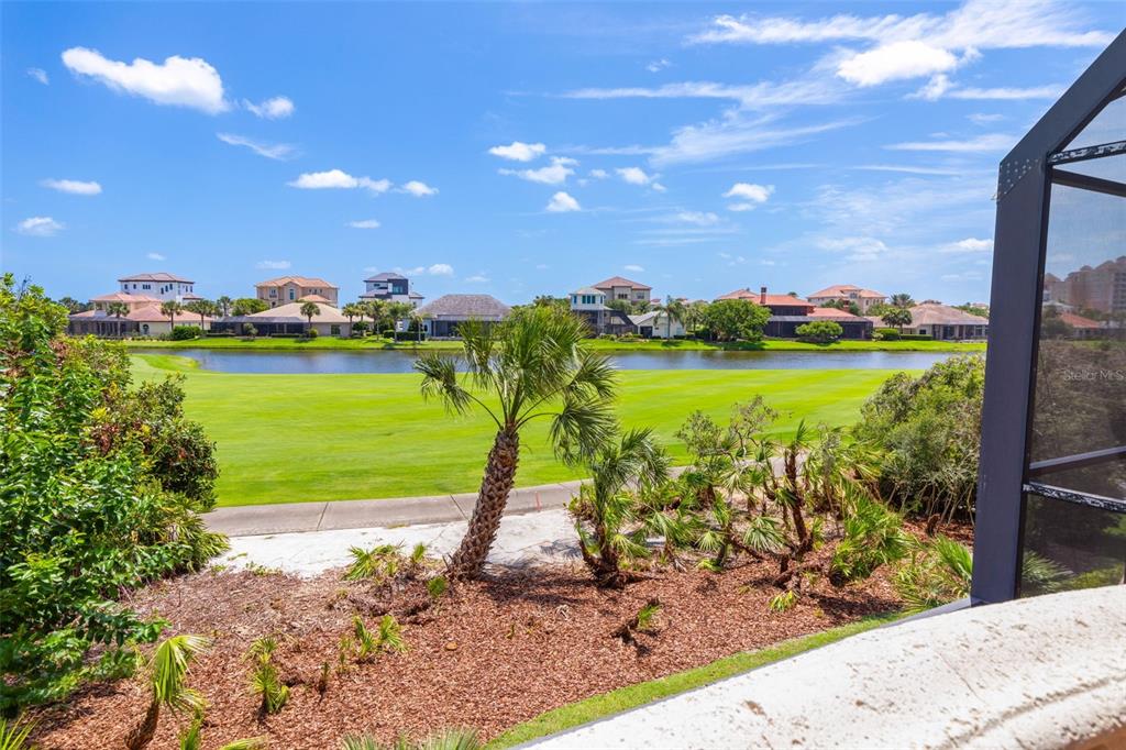 A view of a golf course and pond from a screened-in patio — 44 OCEAN OAKS LANE, PALM COAST, FL