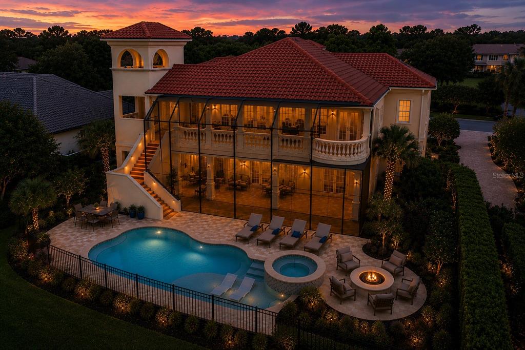 An aerial view of a two-story house with a tiled roof, pool, and screened patio — 44 OCEAN OAKS LANE, PALM COAST, FL