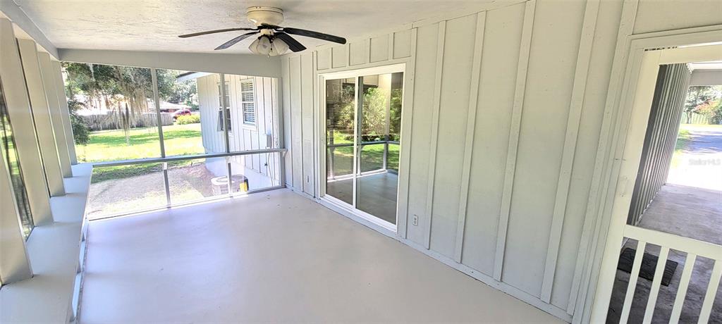 A kitchen features gray cabinets, stainless steel appliances, a tiled backsplash, and light-colored flooring — 1965 MANOR WAY, DELAND, FL