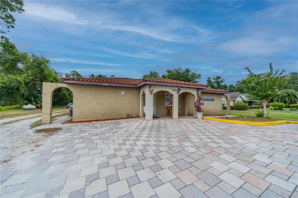 A single-story commercial building with a paved parking lot and a tiled roof — 10508 GIBSONTON DR, RIVERVIEW, FL