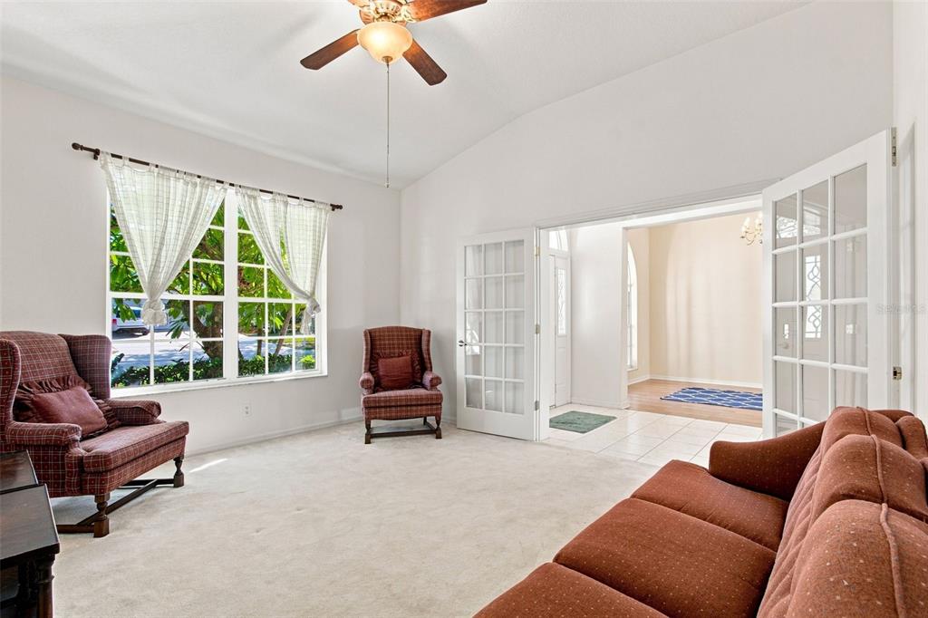 A bright blue front door with sidelights and a transom window sits on a porch — 928 OAKVIEW ROAD, TARPON SPRINGS, FL
