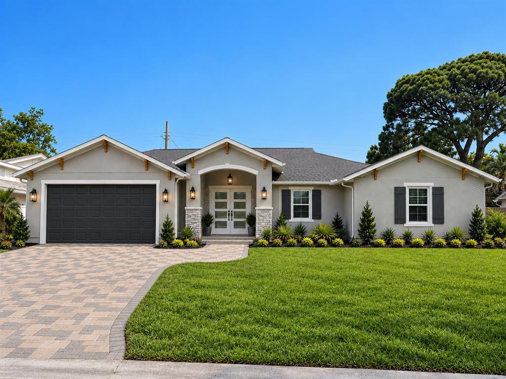 A single-story house with a gray exterior, dark garage door, and a paved driveway — 6941 10TH AVENUE N, ST PETERSBURG, FL