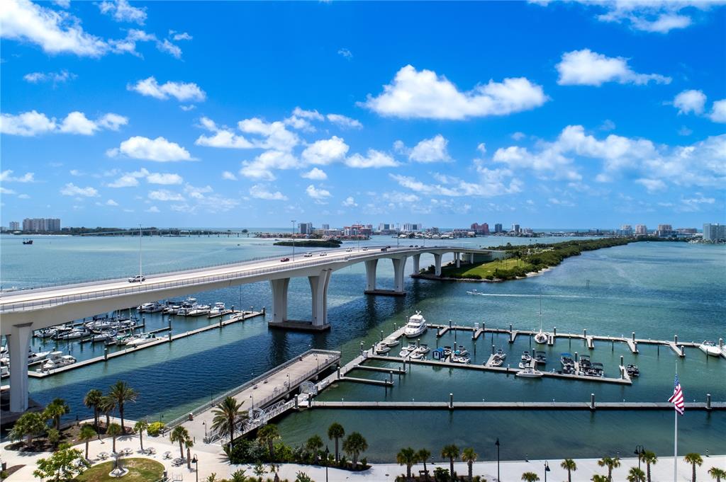 An elevated view shows a bridge spanning a bay with a marina and boats below — 331 CLEVELAND STREET UNIT 213, CLEARWATER, FL
