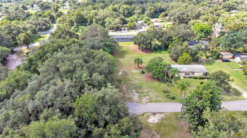 An aerial view shows a residential lot with trees, a house, and a paved road — 0 PERCH STREET, BARTOW, FL