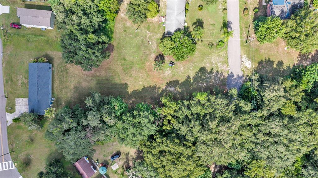 An aerial view shows a residential lot with trees, grass, and several houses — 0 PERCH STREET, BARTOW, FL