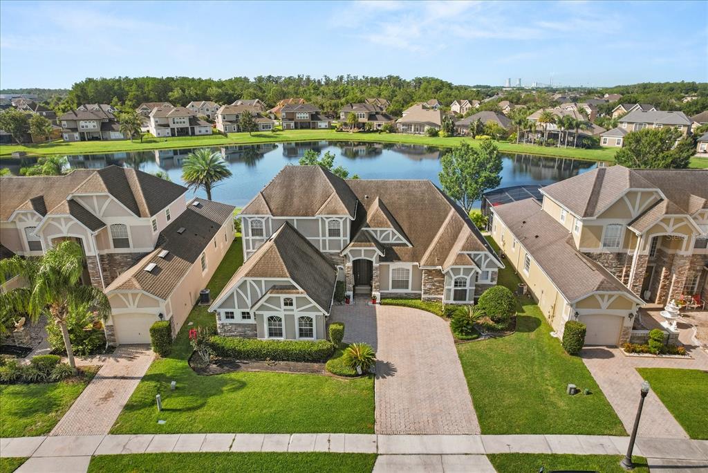 A kitchen with wood cabinets, granite countertops, a center island, and tile flooring — 16108 BRISTOL LAKE CIRCLE, ORLANDO, FL
