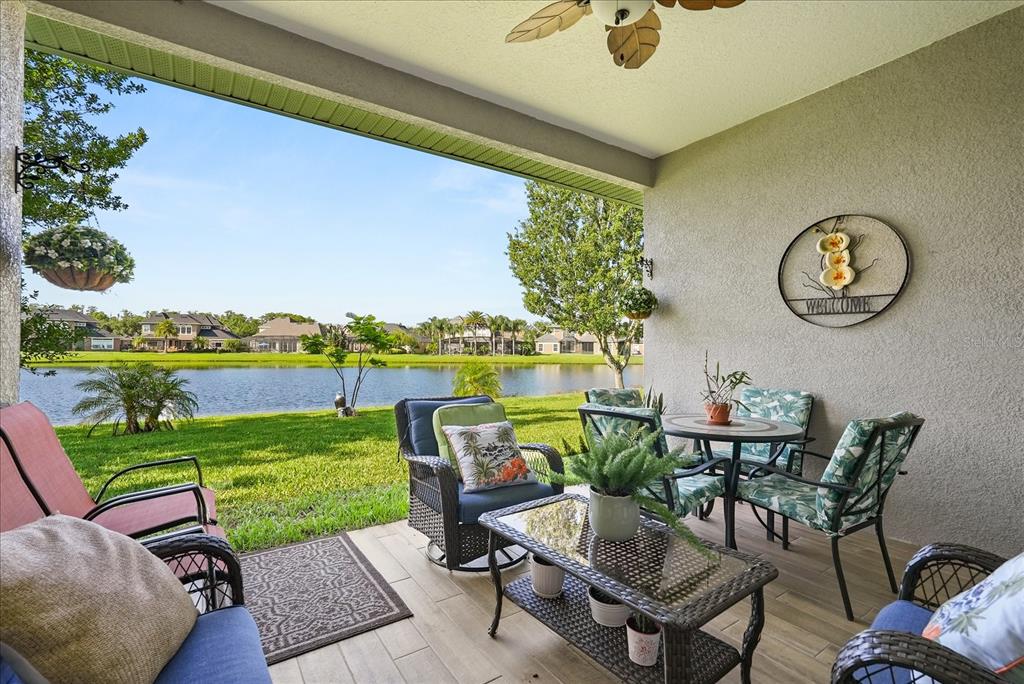 A kitchen features wood cabinets, granite countertops, a center island, and a breakfast bar — 16108 BRISTOL LAKE CIRCLE, ORLANDO, FL